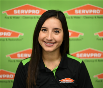image of female sitting in front of SERVPRO backdrop