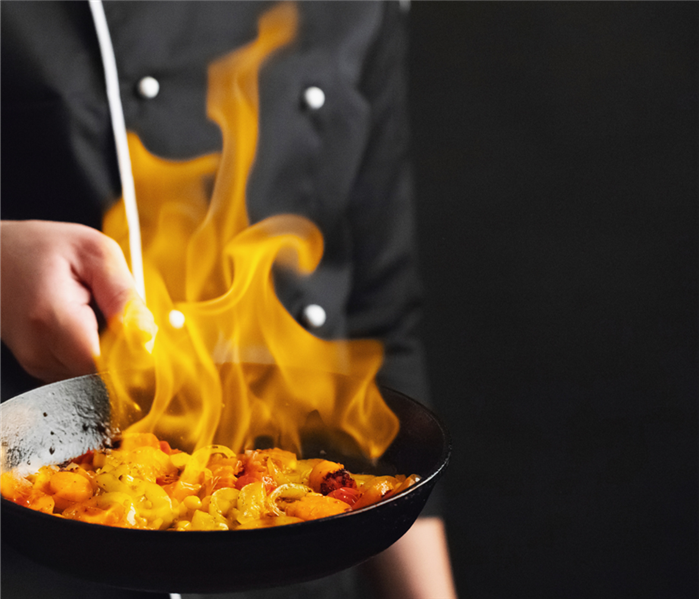 Flames come from a pan with food in it